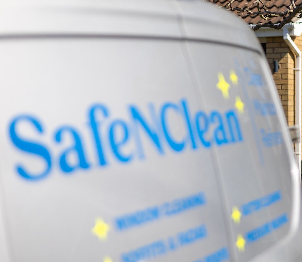 Safe'N'Clean's silver work van with blue branding and a list of the services the team provides